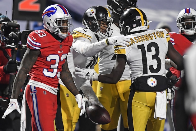 Pittsburgh Steelers wide receiver JuJu Smith-Schuster (19) celebrates with James Washington (13) after taking a 3-yard touchdown pass from quarterback Ben Roethlisberger as Buffalo Bills safety Siran Neal (33) heads back to the sideline during the second half of an NFL football game in Orchard Park, N.Y., Sunday, Dec. 13, 2020. (AP Photo/Adrian Kraus)