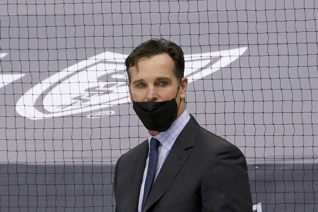 New York Rangers head coach David Quinn works from the bench as his team plays against the Pittsburgh Penguins in an NHL hockey game, Tuesday, March 9, 2021, in Pittsburgh. (AP Photo/Keith Srakocic)