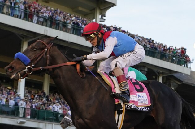 John Velazquez riding Medina Spirit crosses the finish line to win the 147th running of the Kentucky Derby at Churchill Downs, Saturday, May 1, 2021, in Louisville, Ky. (AP Photo/Jeff Roberson)