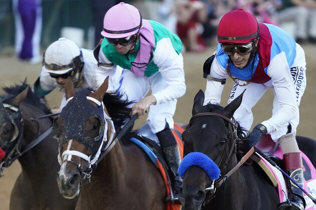 John Velazquez riding Medina Spirit leads Florent Geroux on Mandaloun and Flavien Prat riding Hot Rod Charlie to win the 147th running of the Kentucky Derby at Churchill Downs, Saturday, May 1, 2021, in Louisville, Ky. (AP Photo/Jeff Roberson)