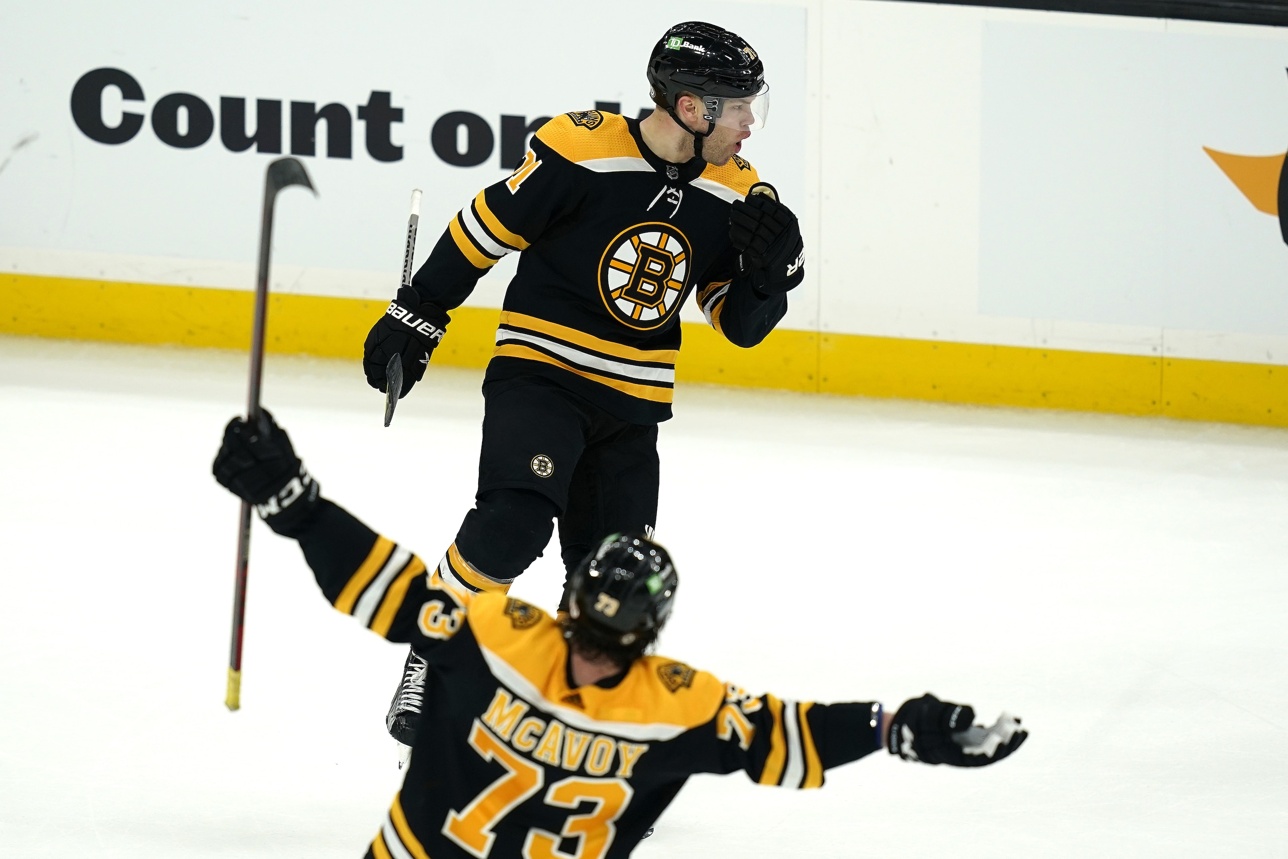 Boston Bruins left wing Taylor Hall (above) celebrates his winning goal with defenseman Charlie McAvoy (73) in the overtime period of an NHL hockey game against the New York Islanders, Monday, May 10, 2021, in Boston.  (AP Photo/Elise Amendola)