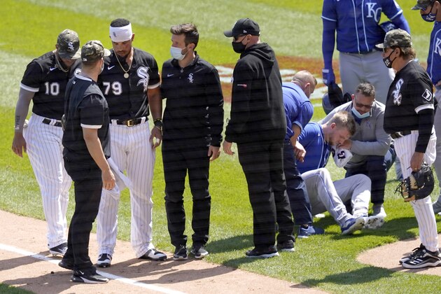 Chicago White Sox's Jose Abreu, left, heads to the dugout as Kansas City Royals' Hunter Dozier tries to get up after they collided along the first base line in the second inning of the first game of a baseball doubleheader Friday, May 14, 2021, in Chicago. (AP Photo/Charles Rex Arbogast) Chicago White Sox's Jose Abreu, left, heads to the dugout as Kansas City Royals' Hunter Dozier tries to get up after they collided along the first base line in the second inning of the first game of a baseball doubleheader Friday, May 14, 2021, in Chicago. (AP Photo/Charles Rex Arbogast)