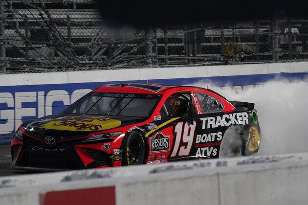 Martin Truex Jr. (19) does a burnout as he celebrates after winning a NASCAR Cup Series auto race at Martinsville Speedway in Martinsville, Va., Sunday, April 11, 2021. (AP Photo/Steve Helber)