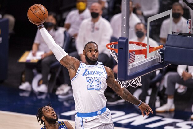 Los Angeles Lakers forward LeBron James (23) goes up high to dunk the ball during the first half of an NBA basketball game against the Indiana Pacers in Indianapolis, Saturday, May 15, 2021. (AP Photo/Doug McSchooler)