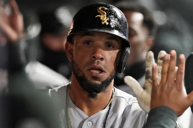 Chicago White Sox's Jose Abreu is congratulated by teammates after hitting a solo home run in the seventh inning in a baseball game against the Cleveland Indians, Tuesday, April 20, 2021, in Cleveland. (AP Photo/Tony Dejak)