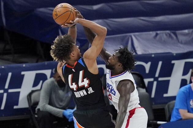 Los Angeles Clippers guard Patrick Beverley, right, defends as Oklahoma City Thunder forward Charlie Brown Jr. (44) shoots in the second half of an NBA basketball game Sunday, May 16, 2021, in Oklahoma City. (AP Photo/Sue Ogrocki)