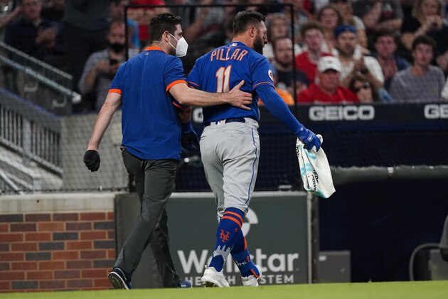 New York Mets center fielder Kevin Pillar (11) is helped to the clubhouse after being hit in the face with a pitch from Atlanta Braves relief pitcher Jacob Webb in the seventh inning of a baseball game Monday, May 17, 2021, in Atlanta. (AP Photo/John Bazemore)