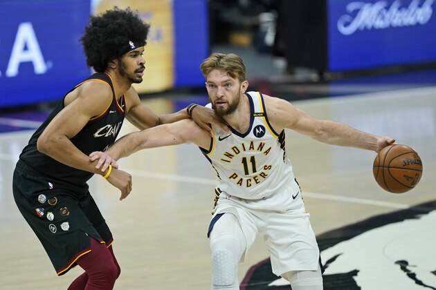 Indiana Pacers' Domantas Sabonis (11) drives past Cleveland Cavaliers' Jarrett Allen (31) in the second half of an NBA basketball game, Monday, May 10, 2021, in Cleveland. (AP Photo/Tony Dejak)
