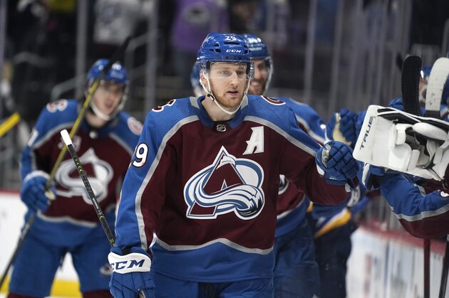 Colorado Avalanche center Nathan MacKinnon is congratulated as he passes the team box after scoring an empty-net goal against the St. Louis Blues late in the third period of Game 1 of an NHL hockey Stanley Cup first-round playoff series Monday, May 17, 2021, in Denver. Colorado won 4-1. (AP Photo/David Zalubowski)