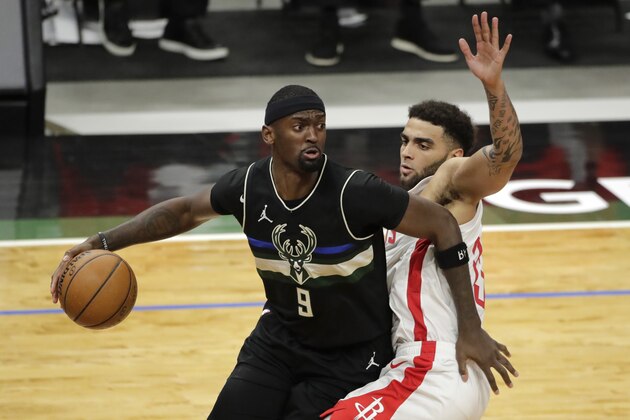 Milwaukee Bucks' Bobby Portis (9) drives to the basket against Houston Rockets' Anthony Lamb during the second half of an NBA basketball game Friday, May 7, 2021, in Milwaukee. (AP Photo/Aaron Gash)