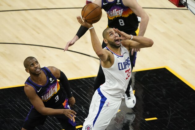 Los Angeles Clippers forward Nicolas Batum (33) shoots as Phoenix Suns guard Chris Paul (3) looks on during the second half of an NBA basketball game, Wednesday, April 28, 2021, in Phoenix. (AP Photo/Matt York)