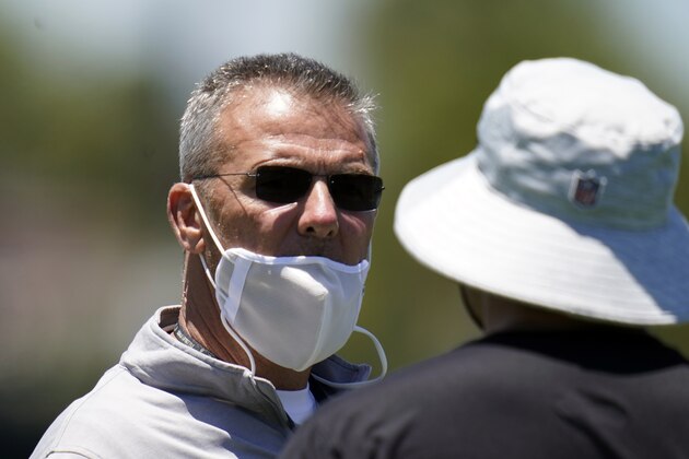 Jacksonville Jaguars head coach Urban Meyer talks with an assistant during an NFL football rookie minicamp, Saturday, May 15, 2021, in Jacksonville, Fla. (AP Photo/John Raoux)