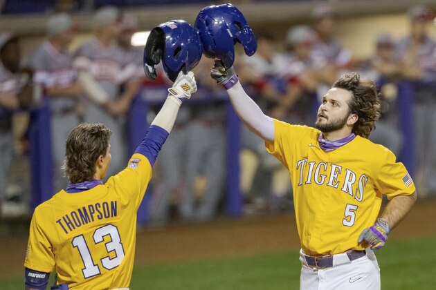 LSU infielder Drew Bianco (5) celebrates a score with LSU infielder Jordan Thompson (13) during an NCAA baseball game on Saturday, Feb. 27, 2021, in Baton Rouge, La. (AP Photo/Matthew Hinton)
