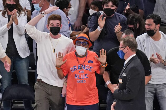 Spike Lee, center, and other fans react during the second half of Game 1 of an NBA basketball first-round playoff series between the New York Knicks and the Atlanta Hawks, Sunday, May 23, 2021, in New York. (AP Photo/Seth Wenig, Pool)