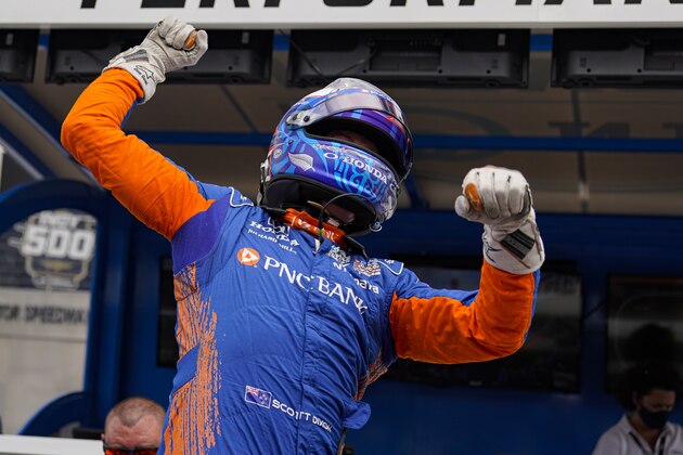 Scott Dixon of New Zealand celebrates after winning the pole during qualifications for the Indianapolis 500 auto race at Indianapolis Motor Speedway in Indianapolis, Sunday, May 23, 2021. (AP Photo/Michael Conroy)