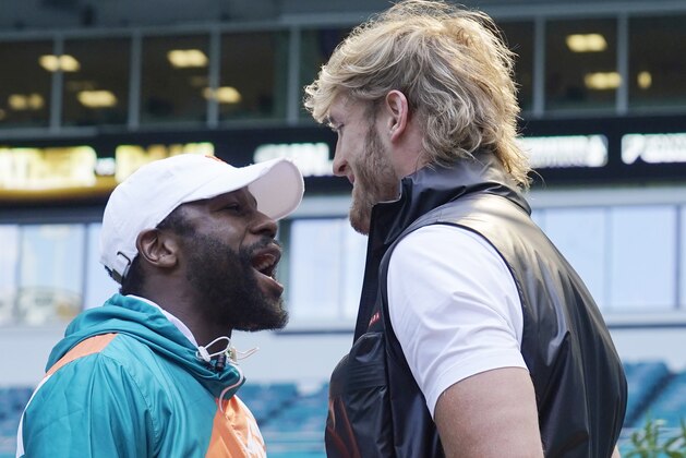 Boxers Floyd Mayweather and Logan Paul taunt each other during a news conference Thursday, May 6, 2021, in Miami Gardens, Fla. Mayweather and Paul are scheduled to face off in an exhibition bout June 6. (AP Photo/Marta Lavandier)