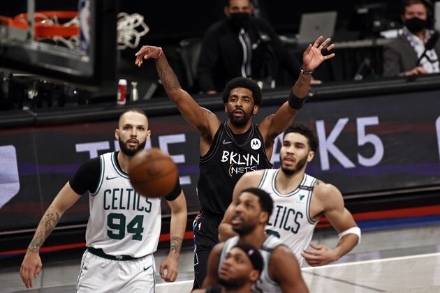 Brooklyn Nets guard Kyrie Irving watches his shot go in the basket next to Boston Celtics forward Jayson Tatum in the second half of Game 5 during an NBA basketball first-round playoff series, Tuesday, June 1, 2021, in New York. (AP Photo/Adam Hunger)