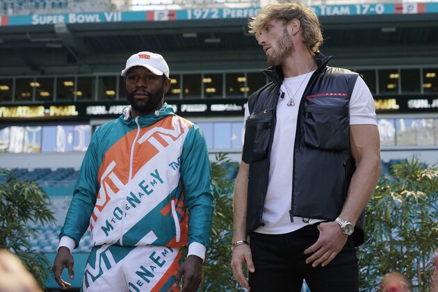 Boxers Floyd Mayweather, left, and Logan Paul stand during a news conference Thursday, May 6, 2021, in Miami Gardens, Fla. Mayweather and Paul are scheduled to face off in an exhibition bout June 6. (AP Photo/Marta Lavandier)
