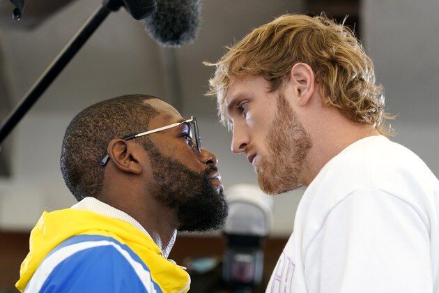 Floyd Mayweather, left, and and Logan Paul, right, face off during a press event, Thursday, June 3, 2021, in Miami Beach, Fla. Mayweather will fight Paul in an exhibition boxing match at the Hard Rock Stadium in Miami Gardens, Fla. Sunday. (AP Photo/Lynne Sladky)