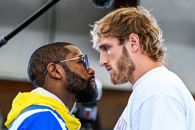 Former world welterweight king Floyd Mayweather (L) and YouTube personality Logan Paul face-off during the media availability ahead of their June 6 exhibition boxing match, on June 3, 2021 at Villa Casa Casuarina at the former Versace Mansion in Miami Beach, on June 3, 2021. (Photo by CHANDAN KHANNA / AFP) (Photo by CHANDAN KHANNA/AFP via Getty Images)