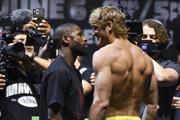 Floyd Mayweather, left, and Logan Paul pose for photographers during a weigh-in Saturday, June 5, 2021, in Hollywood, Fla. Paul is scheduled to fight Mayweather in an exhibition boxing match at Hard Rock Stadium in Miami Gardens, Fla., Sunday. (AP Photo/Jim Rassol)