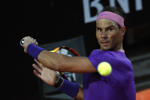 Spain's Rafael Nadal returns the ball to Italy's Jannik Sinner at the Italian Open tennis tournament, in Rome, Wednesday, May 12, 2021. (AP Photo/Alessandra Tarantino)