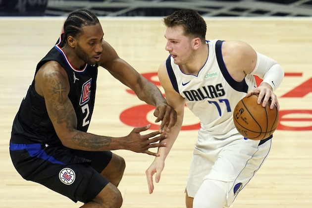 Dallas Mavericks guard Luka Doncic (77) is guarded by Los Angeles Clippers forward Kawhi Leonard (2) during the second half in Game 2 of an NBA basketball first-round playoff series Tuesday, May 25, 2021, in Los Angeles. (AP Photo/Marcio Jose Sanchez)