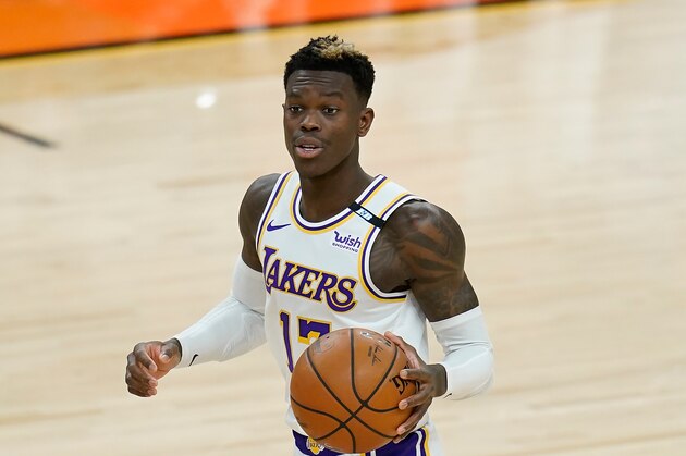 Los Angeles Lakers guard Dennis Schroder dribbles the ball against the Phoenix Suns during the first half of Game 1 of their NBA basketball first-round playoff series Sunday, May 23, 2021, in Phoenix. (AP Photo/Ross D. Franklin)
