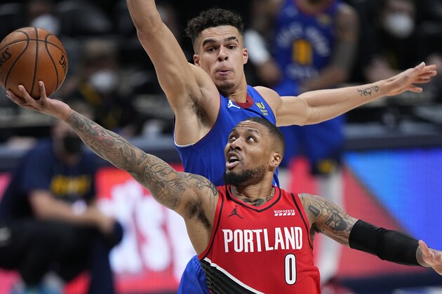 Portland Trail Blazers guard Damian Lillard (0) shoots next to Denver Nuggets forward Michael Porter Jr. (1) during the second half of Game 1 of a first-round NBA basketball playoff series Saturday, May 22, 2021, in Denver. (AP Photo/Jack Dempsey)