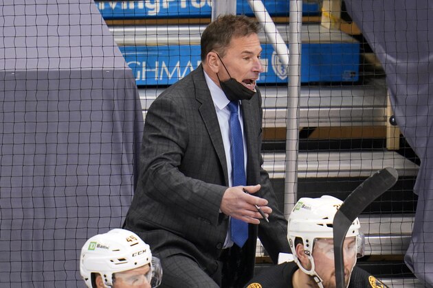 Boston Bruins head coach Bruce Cassidy stands behind his bench during an NHL hockey game against the Pittsburgh Penguins in Pittsburgh, Tuesday, April 27, 2021. The Bruins won 3-1.(AP Photo/Gene J. Puskar)