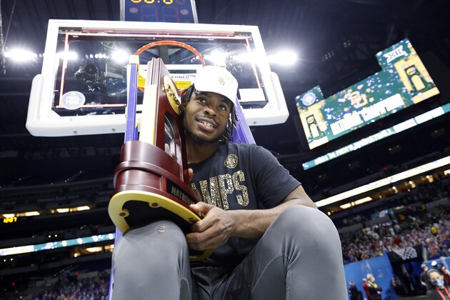 INDIANAPOLIS, INDIANA - APRIL 05: Davion Mitchell #45 of the Baylor Bears sits on a ladder with the trophy after defeating the Gonzaga Bulldogs in the National Championship game of the 2021 NCAA Men's Basketball Tournament at Lucas Oil Stadium on April 05, 2021 in Indianapolis, Indiana. The Baylor Bears defeated the Gonzaga Bulldogs 86-70. (Photo by Jamie Squire/Getty Images)