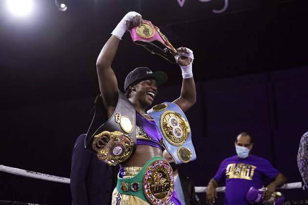 Claressa Shields holds her championship belts after defeating Marie-Eve Dicaire by decision for the women's super welterweight boxing title Friday, March 5, 2021, in Flint, Mich. (AP Photo/Carlos Osorio)