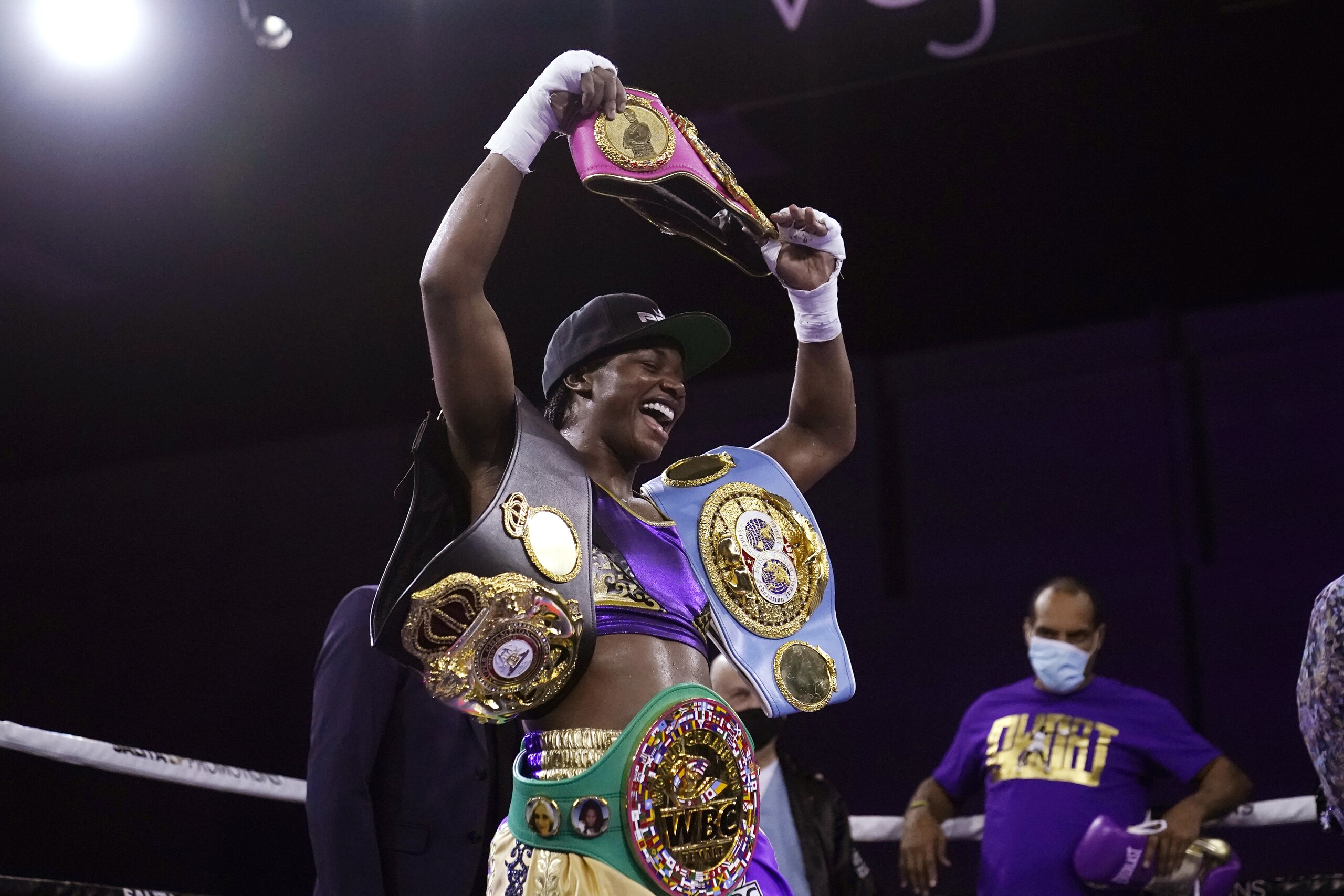Claressa Shields holds her championship belts after defeating Marie-Eve Dicaire by decision for the women's super welterweight boxing title Friday, March 5, 2021, in Flint, Mich. (AP Photo/Carlos Osorio)