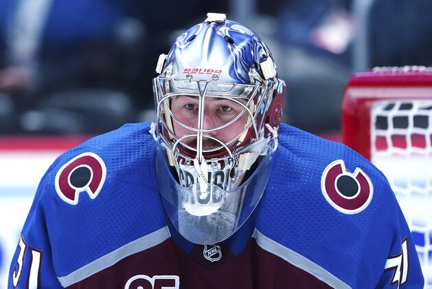 Colorado Avalanche goaltender Philipp Grubauer (31) eyes the puck against the Vegas Golden Knights in the third period of Game 1 of an NHL hockey Stanley Cup second-round playoff series Sunday, May 30, 2021, in Denver. (AP Photo/Jack Dempsey)