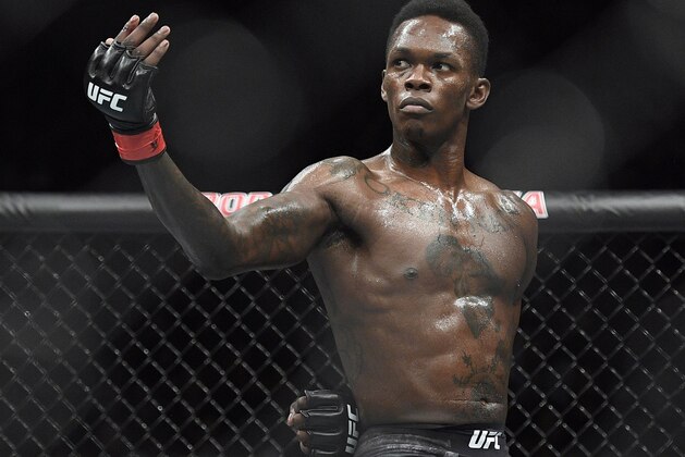 FILE - In this Feb. 10, 2019, file photo, Nigeria's Israel Adesanya poses as he fights Brazil's Anderson Silva in their middleweight bout at the UFC 234 mixed martial arts fights in Melbourne, Australia. Adesanya challenges champion Jan Blachowicz of Poland for the light heavyweight title in the main event of UFC 259 on Saturday in Las Vegas.  (AP Photo/Andy Brownbill, File)