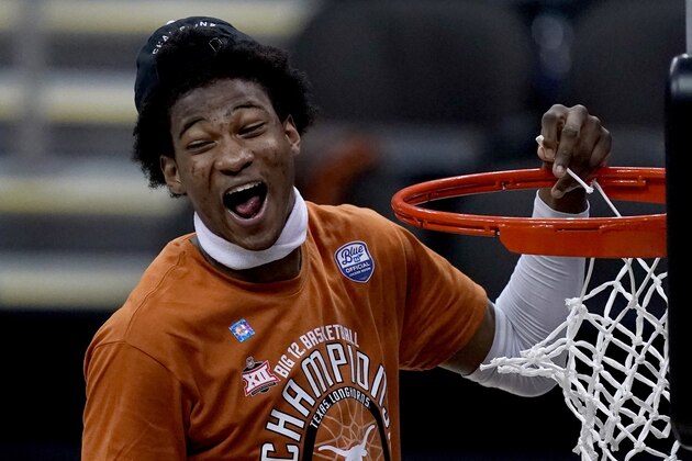 Texas' Kai Jones cuts down the net after the team's win over Oklahoma State in an NCAA college basketball game for the championship of the Big 12 men's tournament in Kansas City, Mo, Saturday, March 13, 2021. (AP Photo/Charlie Riedel)
