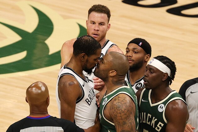 MILWAUKEE, WISCONSIN - JUNE 10: Kevin Durant #7 of the Brooklyn Nets and P.J. Tucker #17 of the Milwaukee Bucks exchange words during the second half of Game Three of the Eastern Conference second round playoff series at the Fiserv Forum on June 10, 2021 in Milwaukee, Wisconsin. NOTE TO USER: User expressly acknowledges and agrees that, by downloading and or using this photograph, User is consenting to the terms and conditions of the Getty Images License Agreement. (Photo by Stacy Revere/Getty Images)