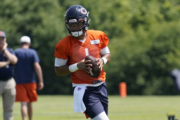 Chicago Bears quarterback Justin Fields works on the field during NFL football practice in Lake Forest, Ill., Wednesday, June 9, 2021. (AP Photo/Nam Y. Huh)