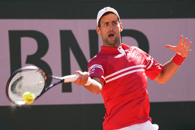 Serbia's Novak Djokovic slams a forehand to Stefanos Tsitsipas of Greece during their final match of the French Open tennis tournament at the Roland Garros stadium Sunday, June 13, 2021 in Paris. (AP Photo/Michel Euler)