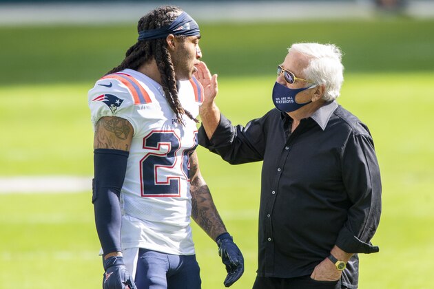 New England Patriots owner Robert Kraft wears a mask on the field as he talks with New England Patriots cornerback Stephon Gilmore (24) before the Patriots take on the Miami Dolphins during an NFL football game, Sunday, Dec. 20, 2020, in Miami Gardens, Fla. (AP Photo/Doug Murray) New England Patriots owner Robert Kraft wears a mask on the field as he talks with New England Patriots cornerback Stephon Gilmore (24) before the Patriots take on the Miami Dolphins during an NFL football game, Sunday, Dec. 20, 2020, in Miami Gardens, Fla. (AP Photo/Doug Murray)