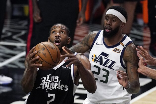 Los Angeles Clippers forward Kawhi Leonard, left, shoots as Utah Jazz forward Royce O'Neale defends during the second half of Game 3 of a second-round NBA basketball playoff series Saturday, June 12, 2021, in Los Angeles. (AP Photo/Mark J. Terrill)