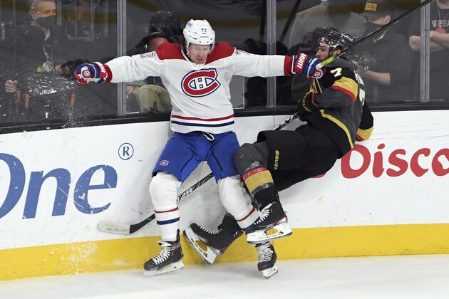 Montreal Canadiens right wing Tyler Toffoli (73) and Vegas Golden Knights defenseman Alex Pietrangelo (7) slam against the boards in Game 2 of an NHL hockey Stanley Cup semifinal playoff series Thursday, June 17, 2021, in Las Vegas. (AP Photo/David Becker)