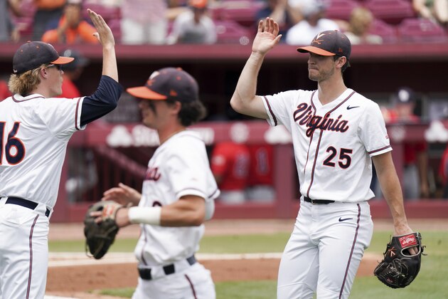 Virginia pitcher Griff McGarry (25) high fives Andrew Abbott (16) in the second inning during an NCAA college baseball tournament super regional game against Dallas Baptist Sunday, June 13, 2021, in Columbia, S.C. Virginia won 4-0. (AP Photo/Sean Rayford)