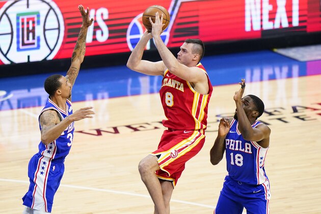 Atlanta Hawks' Danilo Gallinari, center, goes up for a shot against Philadelphia 76ers' George Hill, left, and Shake Milton during the second half of Game 2 in a second-round NBA basketball playoff series, Tuesday, June 8, 2021, in Philadelphia. (AP Photo/Matt Slocum)