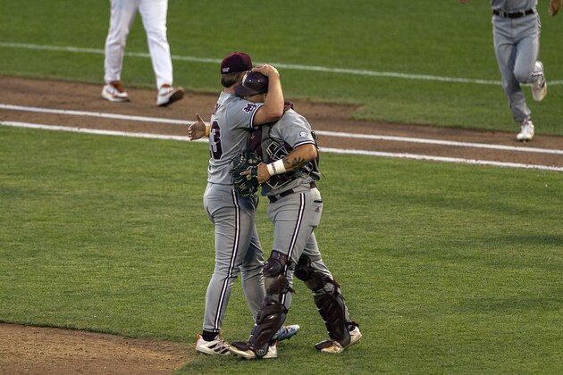 Mississippi State pitcher Landon Sims (23) and catcher Logan Tanner (19) hug as they celebrate a win against Texas in a baseball game in the College World Series, Sunday, June 20, 2021, at TD Ameritrade Park in Omaha, Neb. (AP Photo/John Peterson)