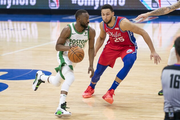 Boston Celtics' Kemba Walker, left, in action against Philadelphia 76ers' Ben Simmons, right, during the second half of an NBA basketball game, Friday, Jan. 22, 2021, in Philadelphia. The 76ers won 122-110. (AP Photo/Chris Szagola)
