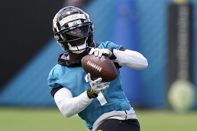 Jacksonville Jaguars running back Travis Etienne catches a pass during an NFL football team practice, Tuesday, June 8, 2021, in Jacksonville, Fla. (AP Photo/John Raoux)