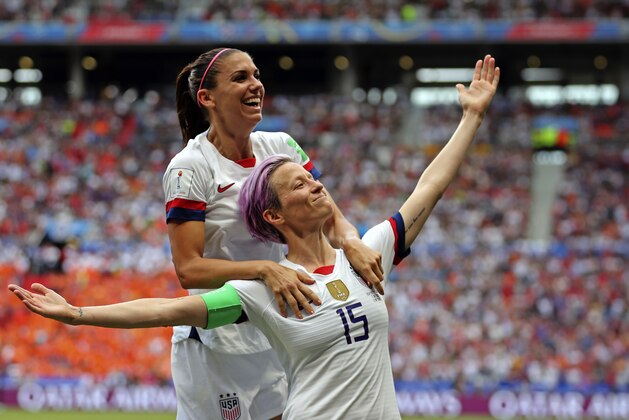 United States' Megan Rapinoe, right, celebrates with Alex Morgan after Rapinoe scored the opening goal from the penalty spot during the Women's World Cup final soccer match between the U.S. and The Netherlands at the Stade de Lyon in Decines, outside Lyon, France, on July 7, 2019. (AP Photo/Francisco Seco)