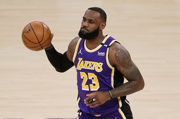 Los Angeles Lakers forward LeBron James dribbles during the first half of an NBA basketball game against the Sacramento Kings Friday, April 30, 2021, in Los Angeles. (AP Photo/Marcio Jose Sanchez)
