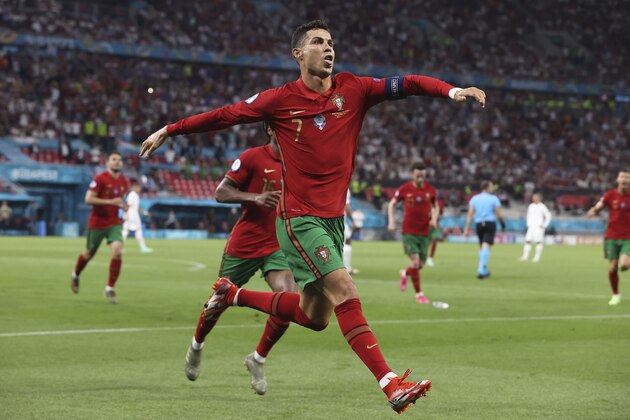 Portugal's Cristiano Ronaldo celebrates after scoring his side's second goal during the Euro 2020 soccer championship group F match between Portugal and France at the Puskas Arena in Budapest, Wednesday, June 23, 2021. (Bernadett Szabo, Pool photo via AP)